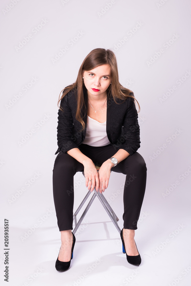 beautiful sexual businesswoman sitting on chair on white background. beautiful sexual businesswoman sitting on chair on white background.