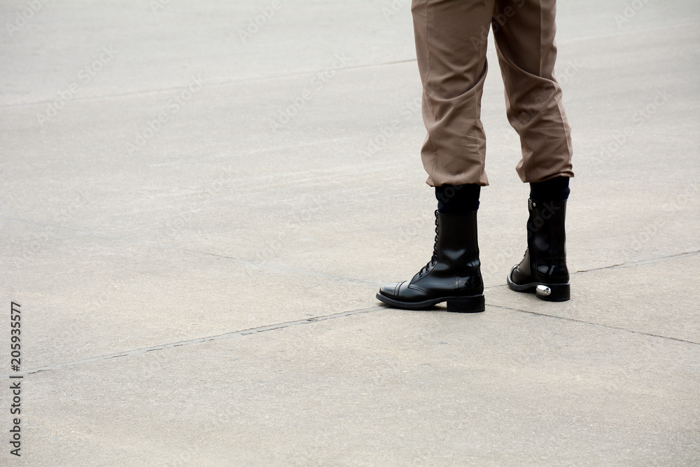boots of soldier standing on the road in urban boots of soldier standing on the road in urban