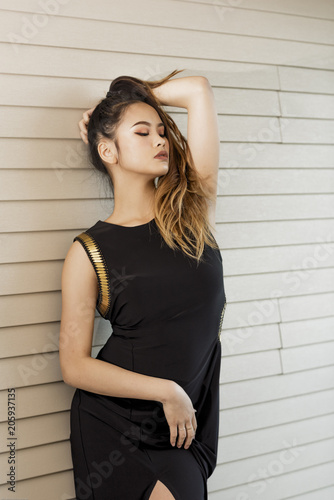 Asian model posing for fashion photography in small boutique