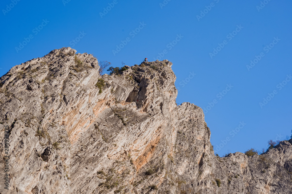Man with helmet ascend to peak Man with helmet ascend to peak