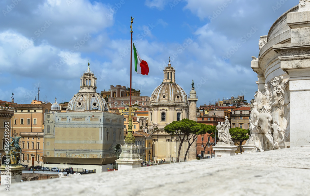 Rome, Italy. Churches, Trajan's Column and italian flag - view from Vittorio Emanuele monument