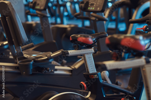 Interior of fitness hall with fitness bicycles. © Fxquadro