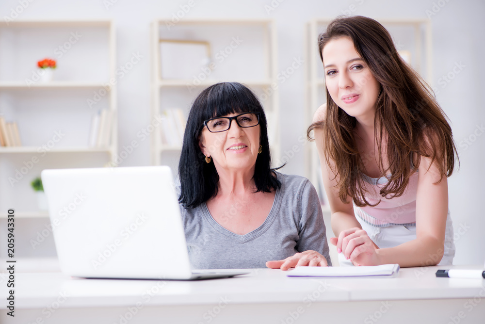Daughter explaining to mom how to use computer Daughter explaining to mom how to use computer
