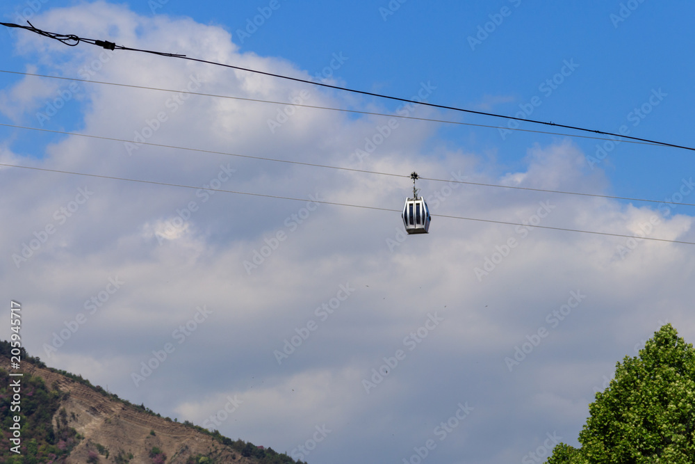 Cabin of the cable car against blue sky. Cableway in Tbilisi, Georgia