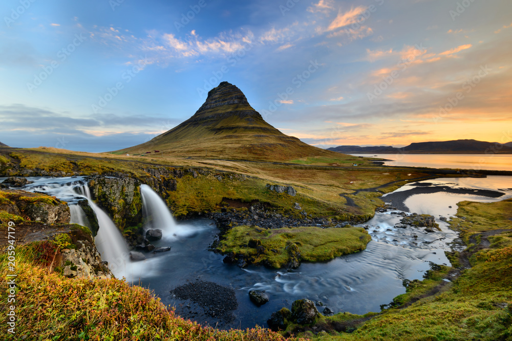 Fototapeta premium Amazing Icelandic landscape at the top of Kirkjufellsfoss waterfall with Kirkjufell mountain in the background on the north coast of Iceland Snaefellsnes peninsula
