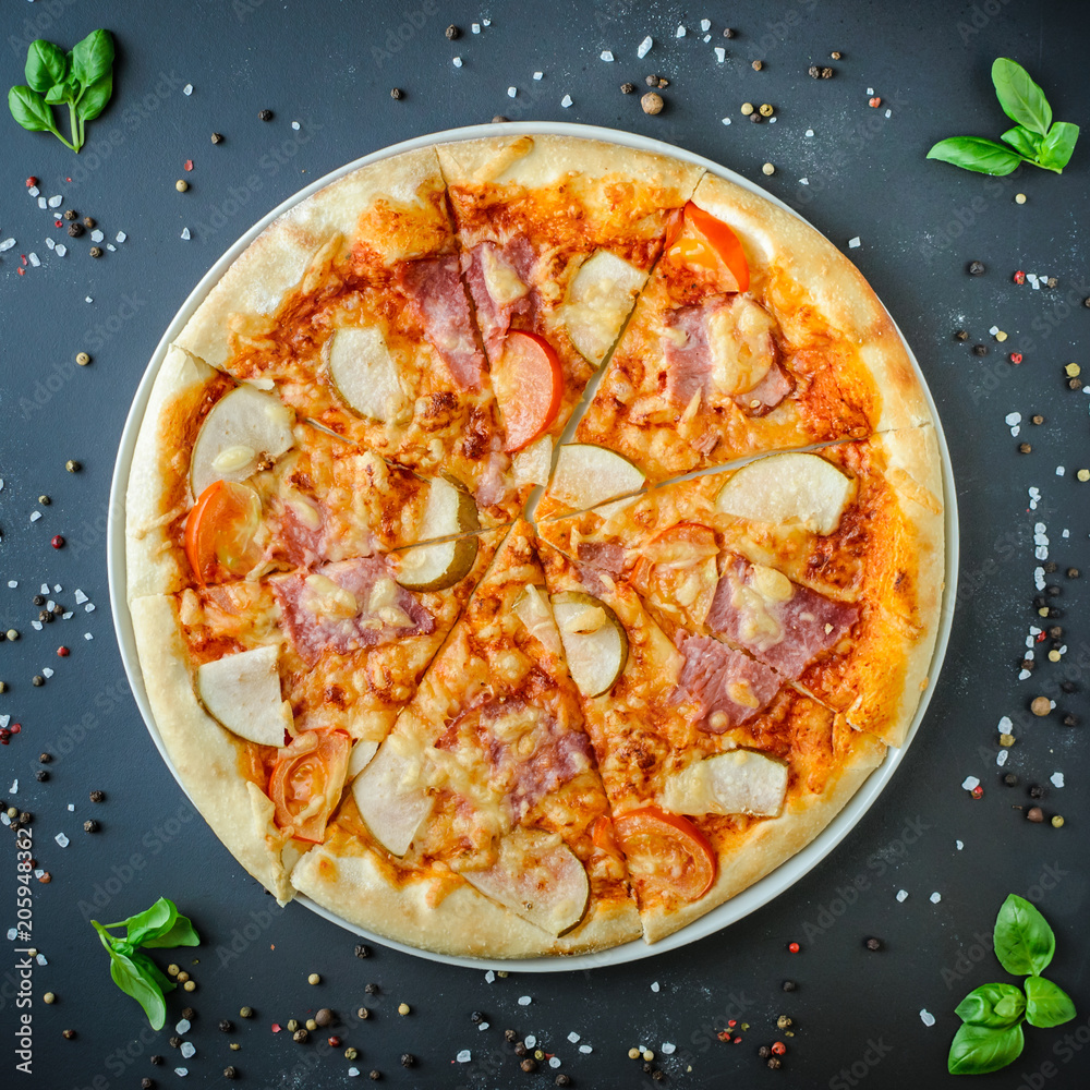 Hawaiian Italian pizza on a dark background