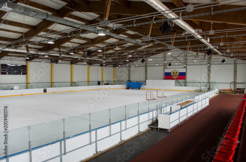 indoor ice arena; ice combine preparing ice; on the wall of the flag of the Russian Federation. General view