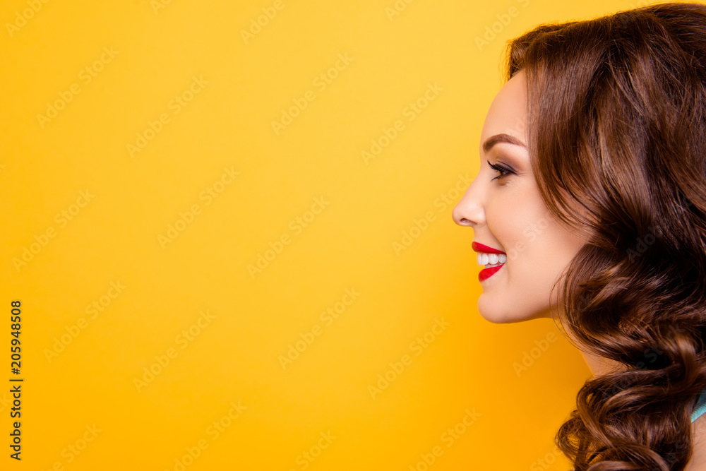 Close up profile portrait with copy space empty place for advertisement of cheerful positive elegant girl with red lipstick makeup isolated on yellow background Close up profile portrait with copy space empty place for advertisement of cheerful positive elegant girl with red lipstick makeup isolated on yellow background