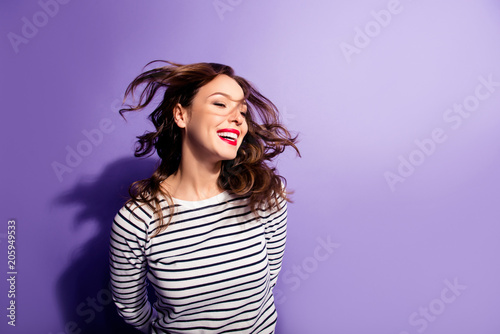 Ha-ha! Portrait with copy space empty place of cheerful laughter funny comic girl having flying hair isolated on violent background, enjoying wind flow