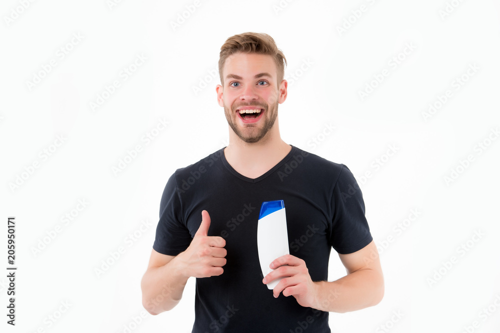 Happy man show thumbs up to shampoo bottle. Bearded man smile with gel tube isolated on white background. Like and approval hand sign. Health and healthcare. Cosmetic for spa and bath or shower Happy man show thumbs up to shampoo bottle. Bearded man smile with gel tube isolated on white background. Like and approval hand sign. Health and healthcare. Cosmetic for spa and bath or shower