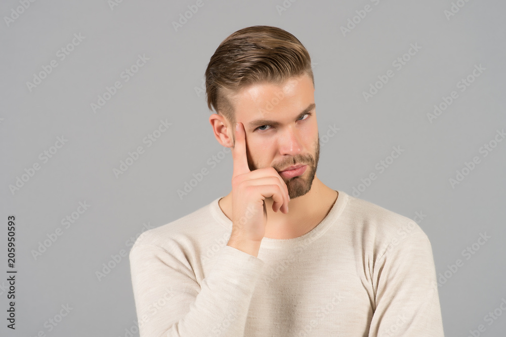 Man with beard on thinking face. Bearded man with blond hair. Skincare and barber salon. Fashion model on grey background. Fashion style and trend concept Man with beard on thinking face. Bearded man with blond hair. Skincare and barber salon. Fashion model on grey background. Fashion style and trend concept