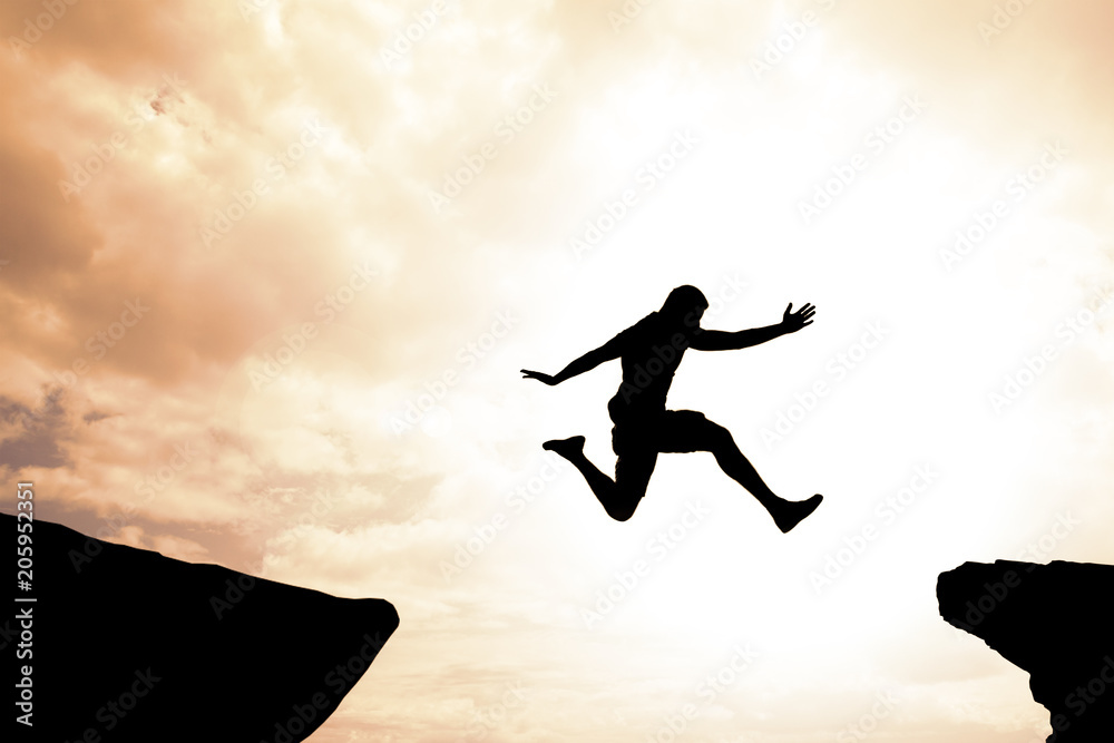 Risk and success concept of brave confident man jumping over gap Risk and success concept of brave confident man jumping over gap