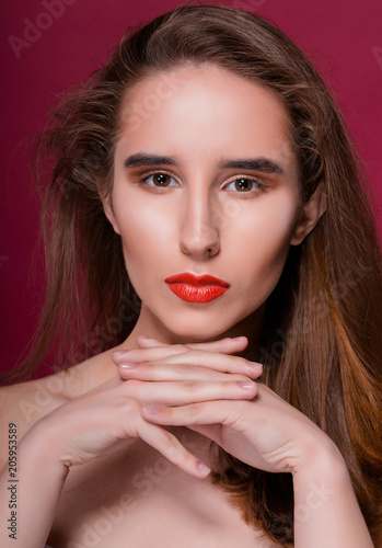 Beauty portrait of gorgeous brunette model with clean skin and red lips