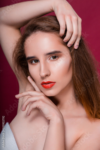 Beauty portrait of young fashionable woman with clean skin and red lips