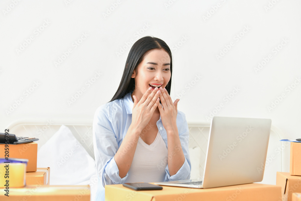 Sme business concept. Young people are packing their packages.Delivery business Small and Medium Enterprise (SMEs). Beautiful women are delighted in success. Sme business concept. Young people are packing their packages.Delivery business Small and Medium Enterprise (SMEs). Beautiful women are delighted in success.
