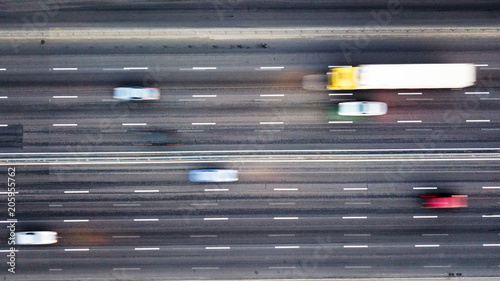 Aerial view road with passing cars blurred background. Photo from the drone