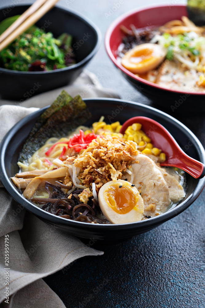 Spicy ramen bowls with noodles, pork and chicken