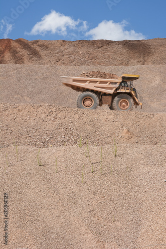 Slopes of an open-pit mine where huge dump trucks are used to uncover precious metals