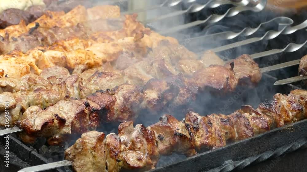 Fried meat is cooked on a barbecue. Shish kebab is fried on fire. Delicious and apetitic meat dinners. Fatty pork ribs. Fried meat is cooked on a barbecue. Shish kebab is fried on fire. Delicious and apetitic meat dinners. Fatty pork ribs.