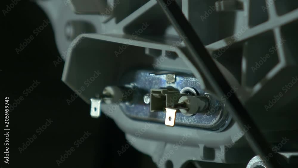 Installing of heating element into washing machine. Worker installs