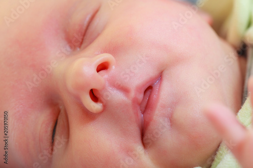 Little newborn baby sleeping calmly in blanket