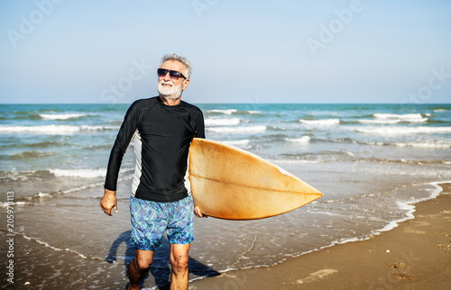 Photography A senior man with a surfboard