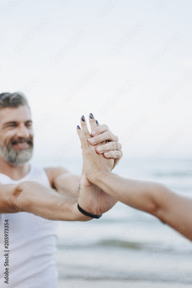 Fototapeta premium Couple stretching at the beach