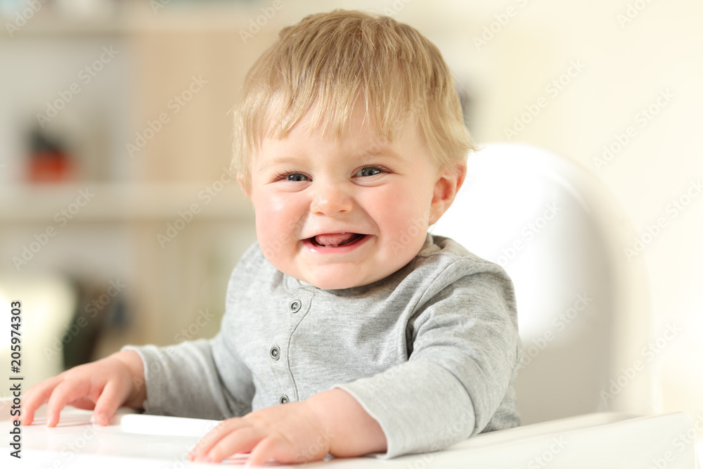 Baby laughing looking at camera on a chair Baby laughing looking at camera on a chair