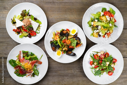 Buffet of delicious mediterranean salads flat lay. Top view on table with assortment of vegetable, seafood and meat meals. Banquet, menu, Italian food 