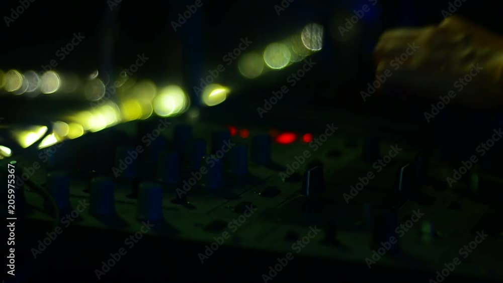 Hands DJ Mixing music in a night club Hands DJ Mixing music in a night club