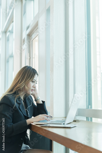 Image of young woman sitting at working