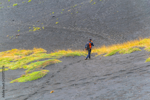 a group of tourist is descending from mount etna in sicily, Italy photo