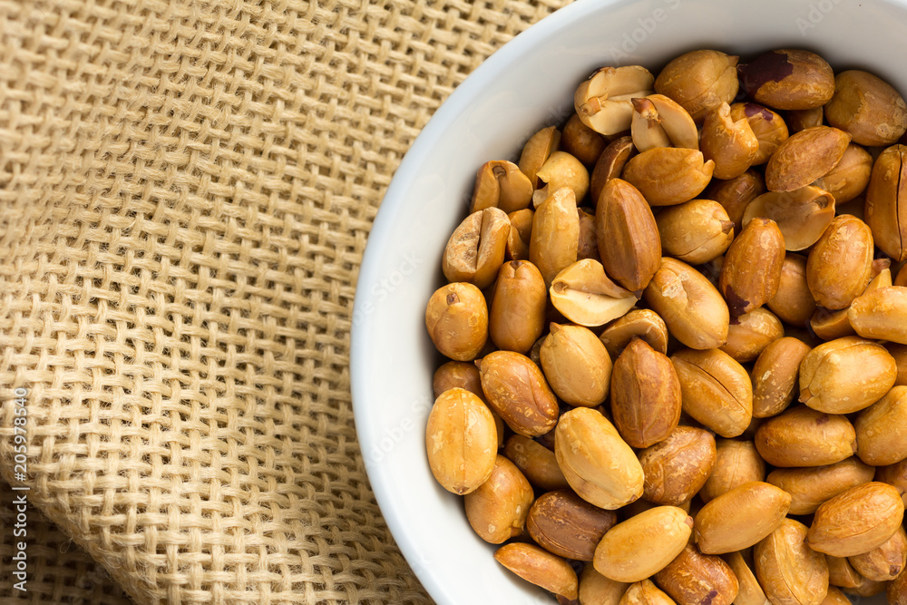 Peanuts. Food of Festa Junina, a typical brazilian party. Snacks on bowl and jute, burlap fabric.