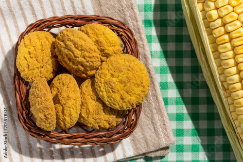 Delicious yellow cookie of corn on basket and corn cob. Sweet food of Festa Junina, a typical brazilian party.