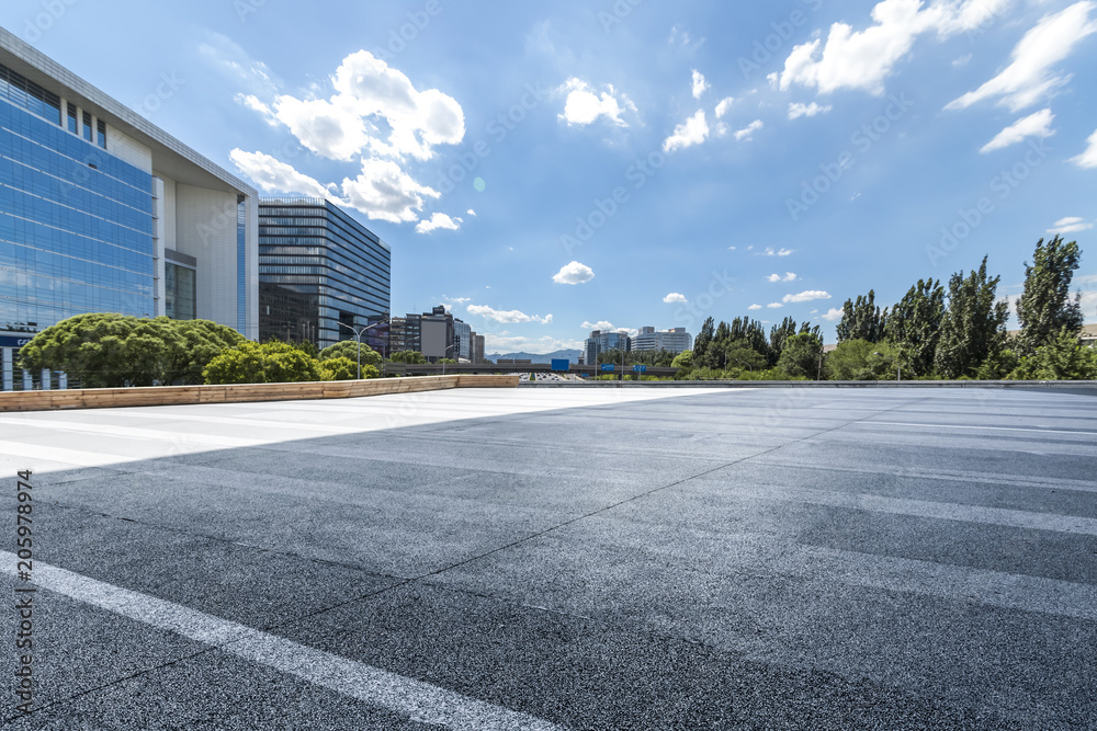 Panoramic skyline and modern business office buildings with empty road,empty concrete square floor Panoramic skyline and modern business office buildings with empty road,empty concrete square floor