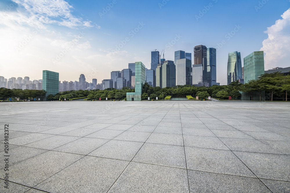 Panoramic skyline and modern business office buildings with empty road,empty concrete square floor Panoramic skyline and modern business office buildings with empty road,empty concrete square floor