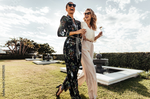 Stylish female friends walking together