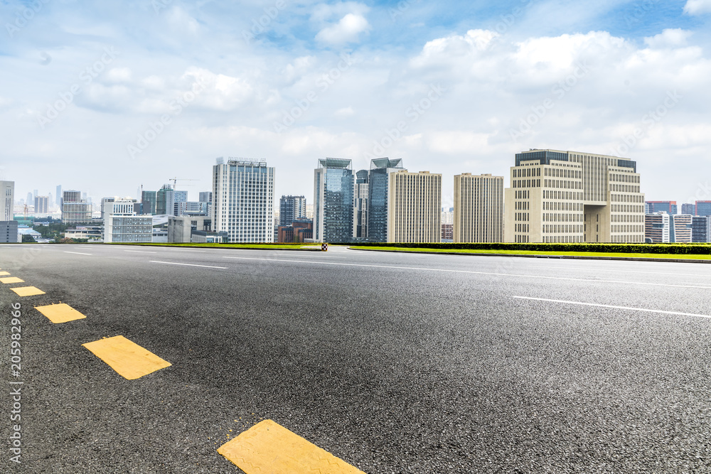 Panoramic skyline and buildings with empty road Panoramic skyline and buildings with empty road