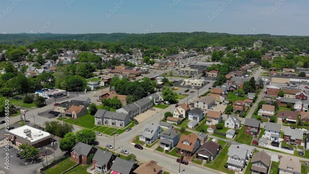 A slowly moving forward aerial establishing shot of a Pennsylvania small town's business and residential districts. Pittsburgh suburbs. A slowly moving forward aerial establishing shot of a Pennsylvania small town's business and residential districts. Pittsburgh suburbs.