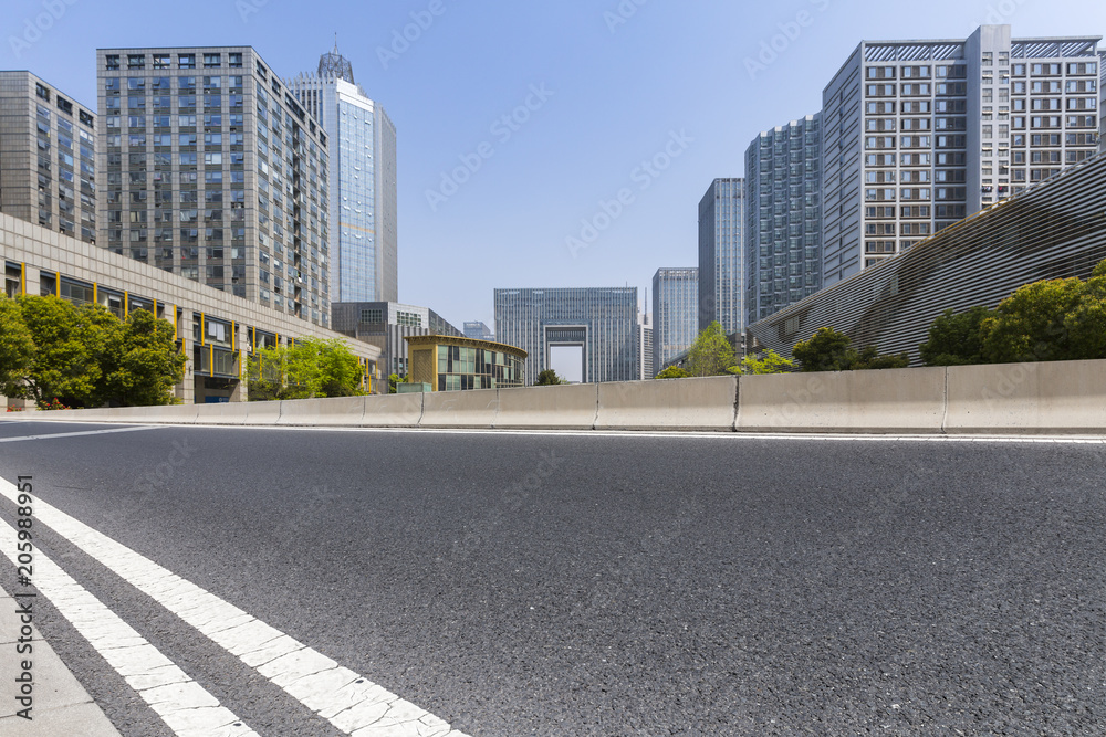 Panoramic skyline and modern business office buildings with empty road,empty concrete square floor Panoramic skyline and modern business office buildings with empty road,empty concrete square floor