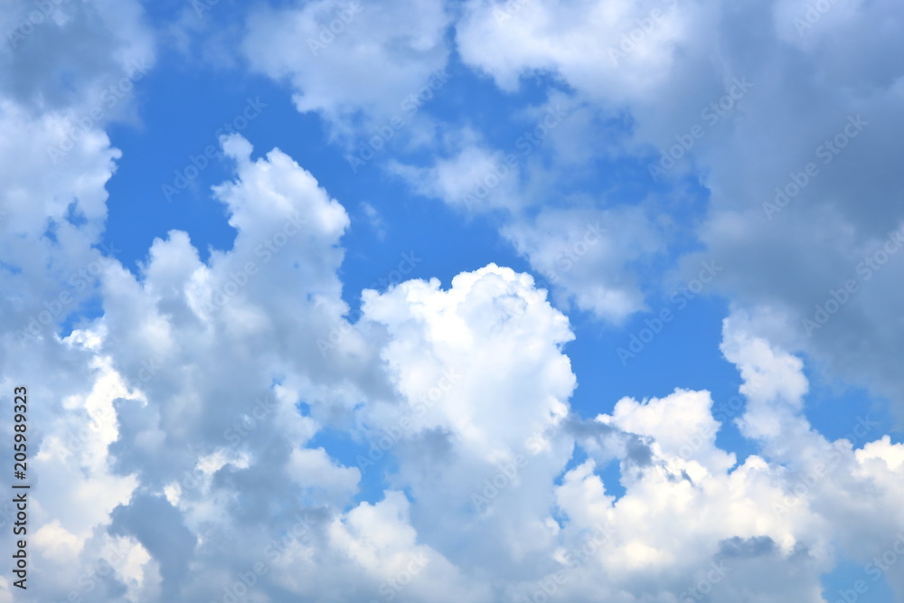 Deep blue sky covered by white fluffy cumulus clouds Deep blue sky covered by white fluffy cumulus clouds