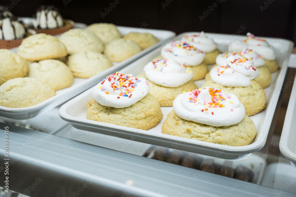 Artisanal cupcakes and cookies at a bakery on display Artisanal cupcakes and cookies at a bakery on display