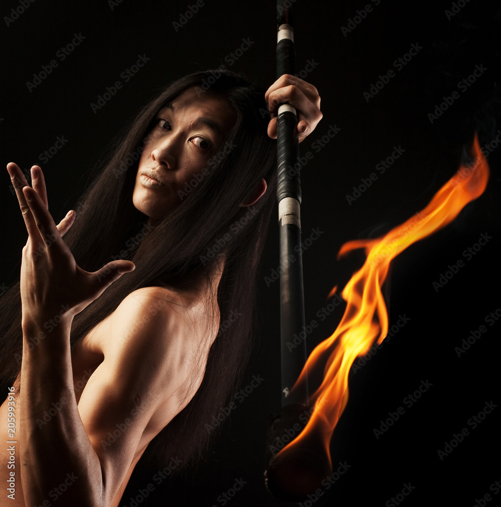 asian man with fire show