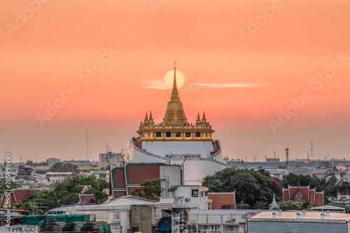 beautiful sunset behind Golden mountain (Wat saket) most famous famous Bangkok Landmark. © pongpinun