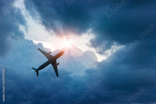 Airplane in dark blue sky and cloud in sunrise