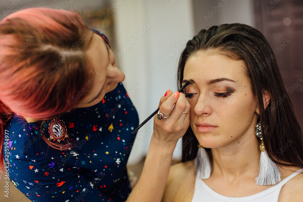 Make-up artist working in studio. Make-up artist working in studio.