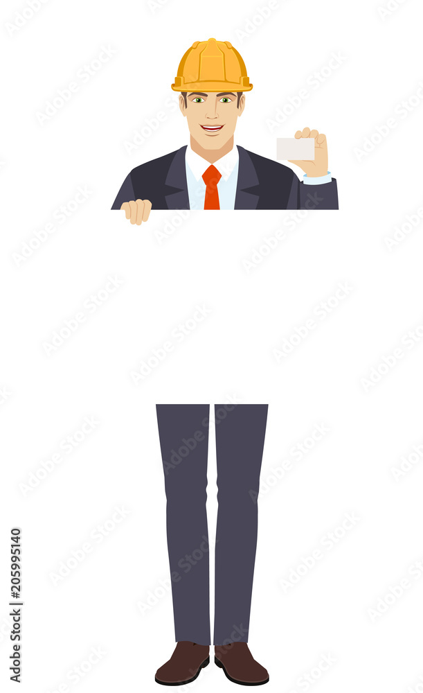 Businessman in construction helmet holding white blank poster and showing the business card Businessman in construction helmet holding white blank poster and showing the business card