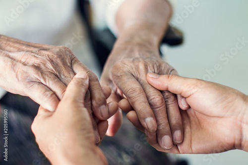 Fototapeta Naklejka Na Ścianę i Meble -  Close up hands of helping hands elderly home care. Mother and daughter. Mental health and elderly care concept