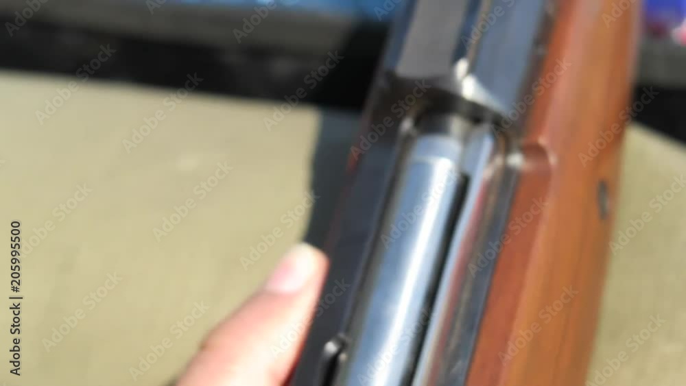 Close up video of a bullet being loaded into a heavy caliber hunting rifle Close up video of a bullet being loaded into a heavy caliber hunting rifle