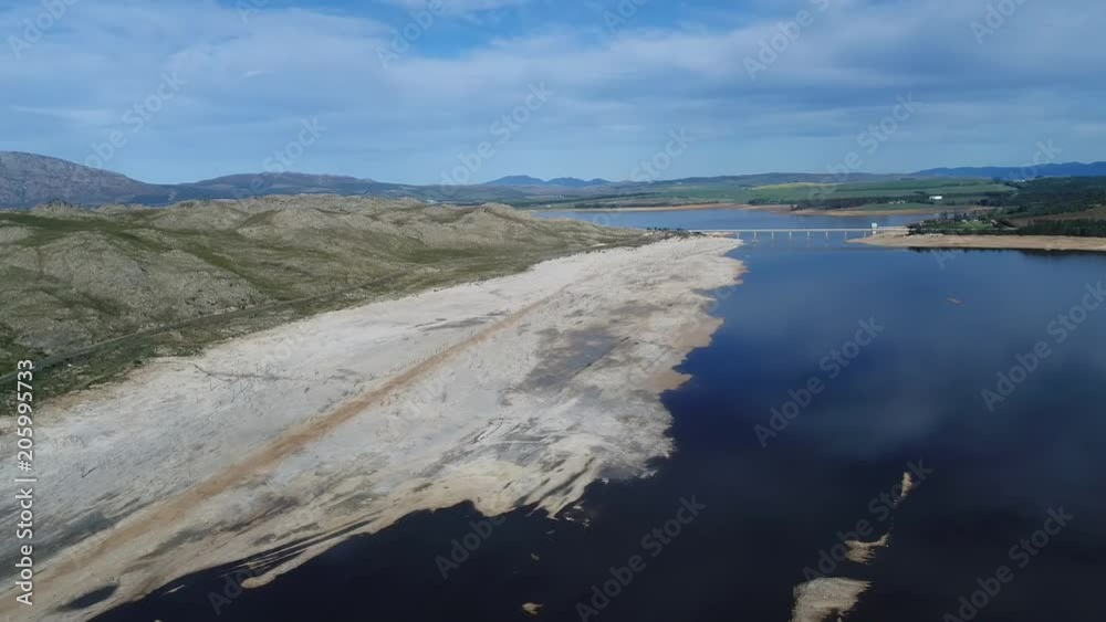 Aerial drone shot over a sandy shore with lakes and mountains in South Africa Aerial drone shot over a sandy shore with lakes and mountains in South Africa